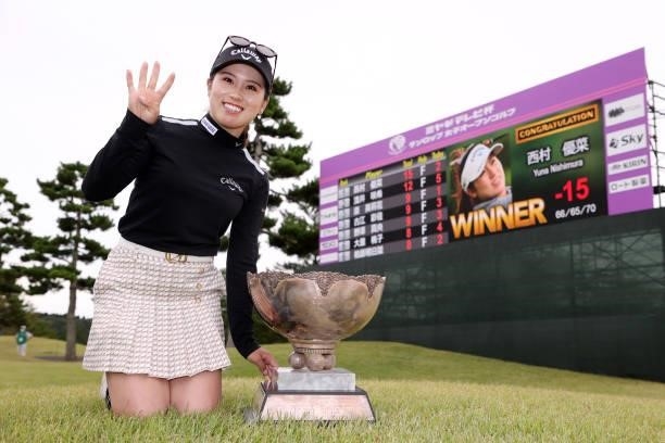 Yuna Nishimura of Japan poses after winning the tournament following the final round of the Miyagi TV Cup Dunlop Ladies Open at Rifu Golf Club on...