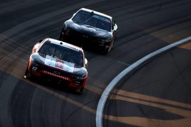 Blaine Perkins, driver of the Chevrolet, and Matt Mills, driver of the J.F. Electric Toyota, race during the NASCAR Xfinity Series Alsco Uniforms 302...