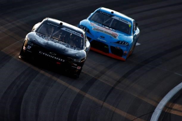 Josh Williams, driver of the Silverton Hotel & Casino Chevrolet, and David Starr, driver of the Angry Crab Shack Toyota, race during the NASCAR...