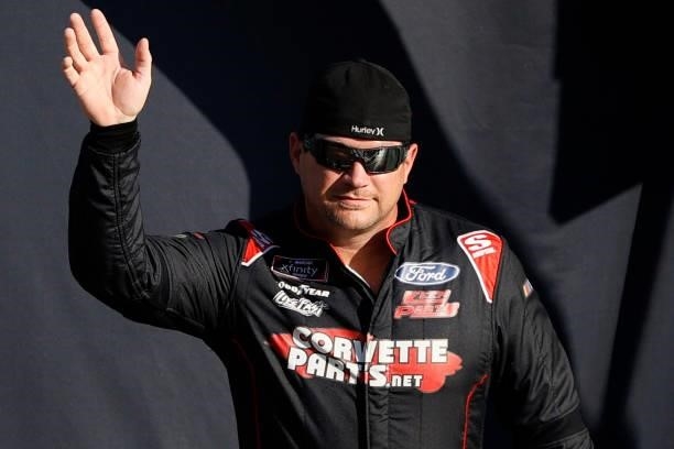 McLeod, driver of the BJ McLeod Motorsports Chevrolet, waves to fans during pre-race ceremonies prior to the NASCAR Xfinity Series Alsco Uniforms 302...