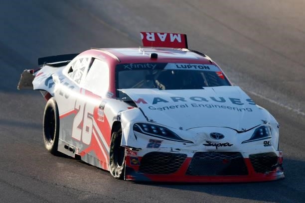 Dylan Lupton, driver of the Marques General Engineering Toyota, drives a damaged car after an on-track incident during the NASCAR Xfinity Series...