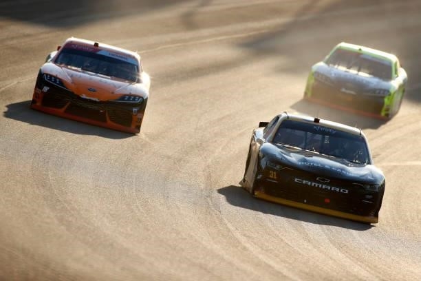 Ty Dillon, driver of the South Point Hotel & Casino Chevrolet, and Daniel Hemric, driver of the Poppy Bank Toyota, race during the NASCAR Xfinity...