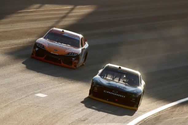 Ty Dillon, driver of the South Point Hotel & Casino Chevrolet, and Daniel Hemric, driver of the Poppy Bank Toyota, race during the NASCAR Xfinity...
