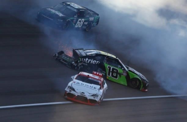 Jeb Burton, driver of the Nutrien Ag Solutions Chevrolet, and Dylan Lupton, driver of the Marques General Engineering Toyota, spin after an on-track...