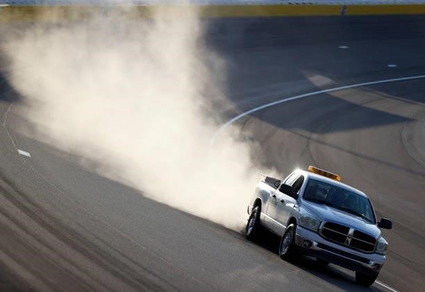 The track crew cleans the driving surface after an incident during the NASCAR Xfinity Series Alsco Uniforms 302 at Las Vegas Motor Speedway on...