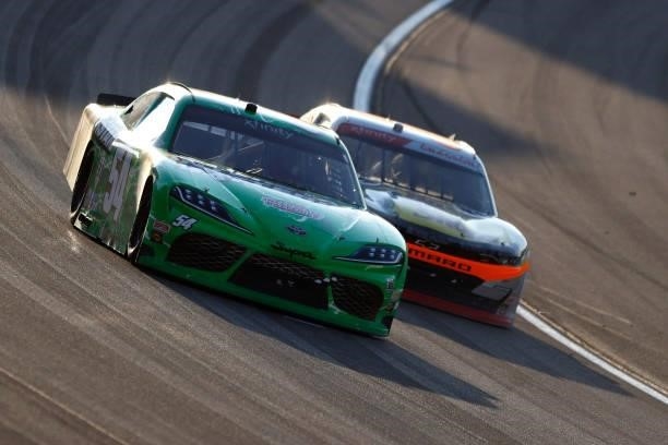 Ty Gibbs, driver of the Interstate Batteries Toyota, and Noah Gragson, driver of the Bass Pro Shops/TrueTimber/BRCC Chevrolet, race during the NASCAR...