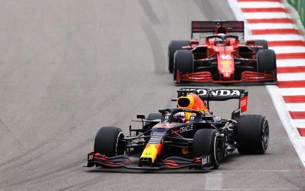 Max Verstappen of the Netherlands driving the Red Bull Racing RB16B Honda leads Charles Leclerc of Monaco driving the Scuderia Ferrari SF21 during...