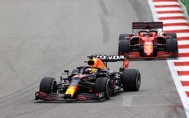 Max Verstappen of the Netherlands driving the Red Bull Racing RB16B Honda leads Charles Leclerc of Monaco driving the Scuderia Ferrari SF21 during...