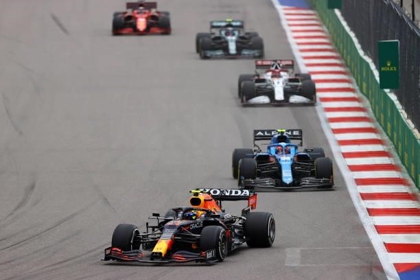 Sergio Perez of Mexico driving the Red Bull Racing RB16B Honda leads Esteban Ocon of France driving the Alpine A521 Renault during the F1 Grand Prix...