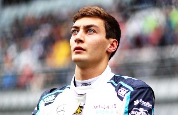 George Russell of Great Britain and Williams looks on from the grid before the F1 Grand Prix of Russia at Sochi Autodrom on September 26, 2021 in...