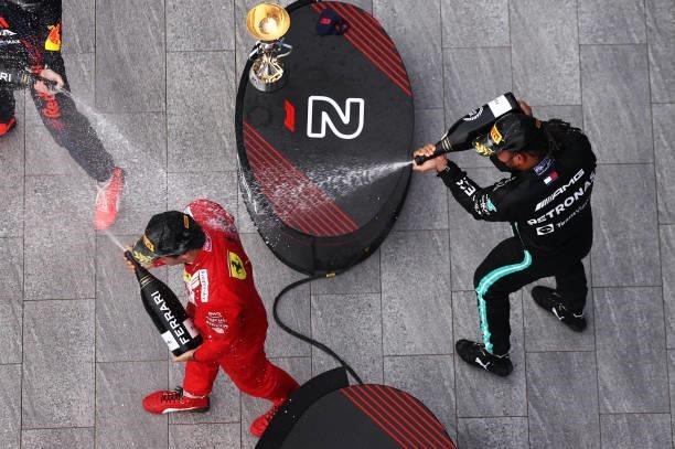 Race winner Lewis Hamilton of Great Britain and Mercedes GP and third placed Carlos Sainz of Spain and Ferrari celebrate on the podium during the F1...