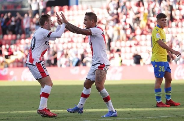 Oscar Trejo and Ivan Balliu of Rayo Vallecano celebrate their side's first goal scored by Alvaro Garcia of Rayo Vallecano during the LaLiga Santander...