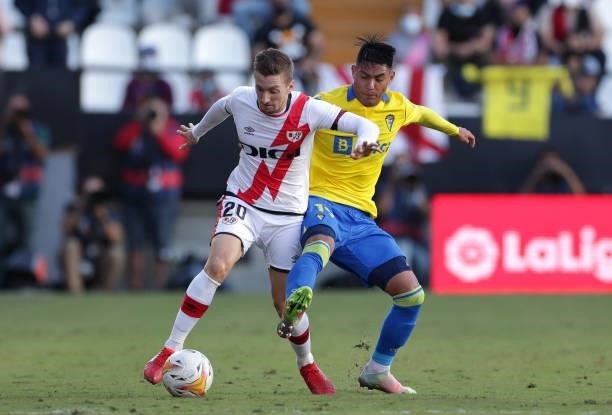 Ivan Balliu of Rayo Vallecano battles for possession with Santiago Arzamendia of Cadiz during the LaLiga Santander match between Rayo Vallecano and...