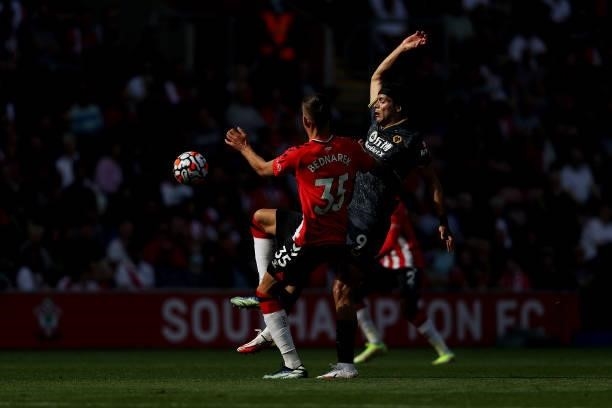 Raul Jimenez of Wolverhampton Wanderers is challenged by Jan Bednarek of Southampton during the Premier League match between Southampton and...
