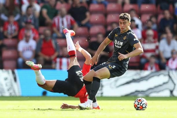 Maximilian Kilman of Wolverhampton Wanderers is challenged by Che Adams of Southampton during the Premier League match between Southampton and...