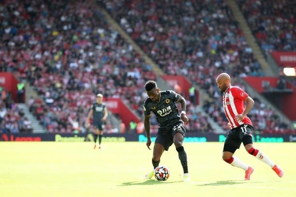 Nelson Semedo of Wolverhampton Wanderers is challenged by Nathan Redmond of Southampton during the Premier League match between Southampton and...