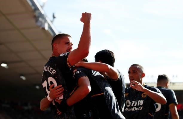 Raul Jimenez of Wolverhampton Wanderers celebrates with teammates after scoring his team's first goal during the Premier League match between...
