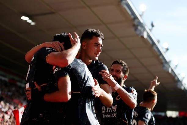 Raul Jimenez of Wolverhampton Wanderers celebrates with teammates after scoring his team's first goal during the Premier League match between...