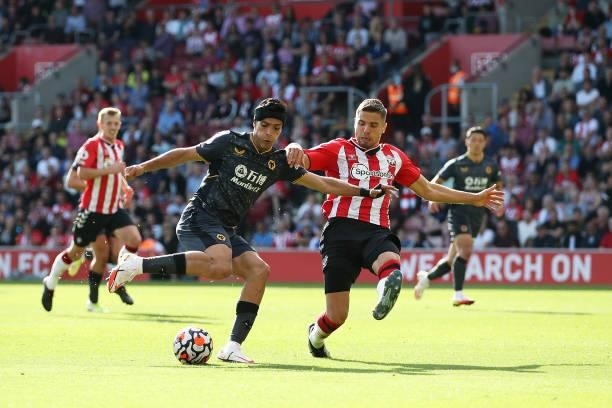 Raul Jimenez of Wolverhampton Wanderers crosses over Jan Bednarek of Southampton during the Premier League match between Southampton and...