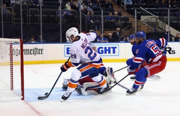 Brock Nelson of the New York Islanders scores a first period goal against Alexandar Georgiev of the New York Rangers in a preseason game at Madison...
