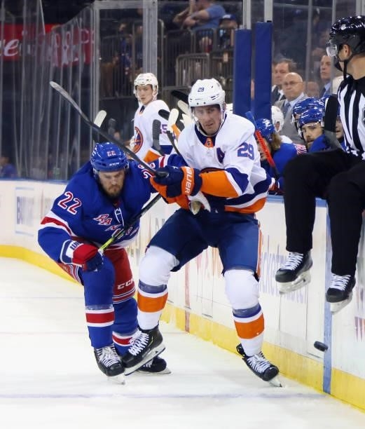 Anthony Bitetto of the New York Rangers slows up Brock Nelson of the New York Islanders during the first period in a preseason game at Madison Square...