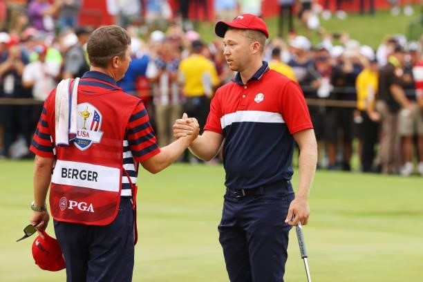 Daniel Berger of team United States celebrates with his caddie Josh Cassell on the 18th green during Sunday Singles Matches of the 43rd Ryder Cup at...