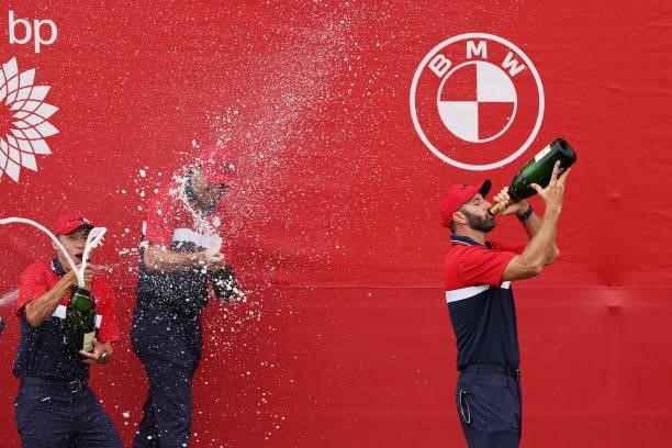 Dustin Johnson of team United States celebrates with champagne after defeating team Europe during Sunday Singles Matches of the 43rd Ryder Cup at...