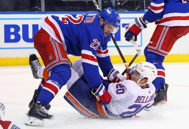 Anthony Bitetto of the New York Rangers checks Kieffer Bellows of the New York Islanders during the third period in a preseason game at Madison...