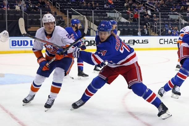 Kieffer Bellows of the New York Islanders skates against Vitali Kravtsov of the New York Rangers during the third period in a preseason game at...