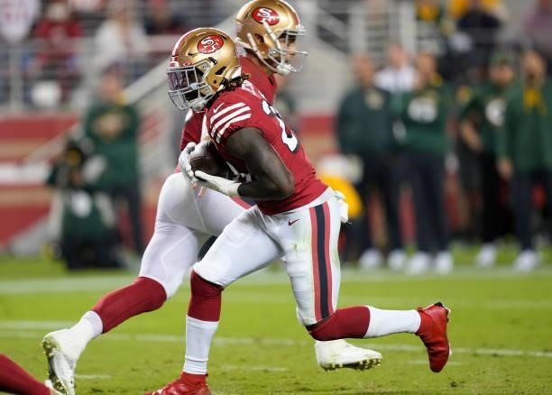 Jimmy Garoppolo of the San Francisco 49ers hands off to Trey Sermon during the second half against the Green Bay Packers in the game at Levi's...