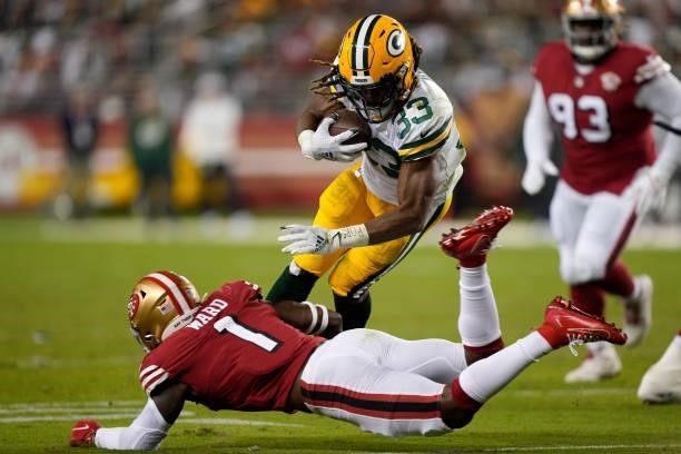 Aaron Jones of the Green Bay Packers is tackled during the second half by a San Francisco 49ers defender in the game at Levi's Stadium on September...