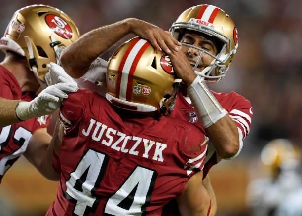 Kyle Juszczyk and Jimmy Garoppolo of the San Francisco 49ers celebrate after a touchdown during the fourth quarter against the Green Bay Packers in...