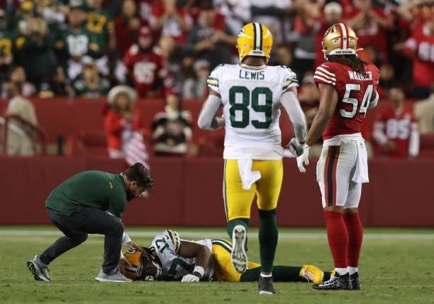 Davante Adams of the Green Bay Packers is injured trying to catch a pass during the fourth quarter against the San Francisco 49ers in the game at...