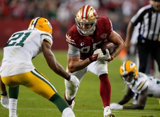 George Kittle of the San Francisco 49ers runs after catching a pass during the fourth quarter against the Green Bay Packers in the game at Levi's...
