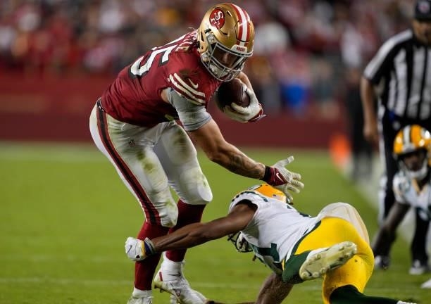 George Kittle of the San Francisco 49ers runs after catching a pass during the fourth quarter against the Green Bay Packers in the game at Levi's...