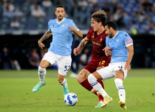 Nicolo Zaniolo of AS Roma competes for the ball with Pedro Rodriguez and Danilo Cataldi of SS Lazio ,during the Serie A match between SS Lazio and AS...
