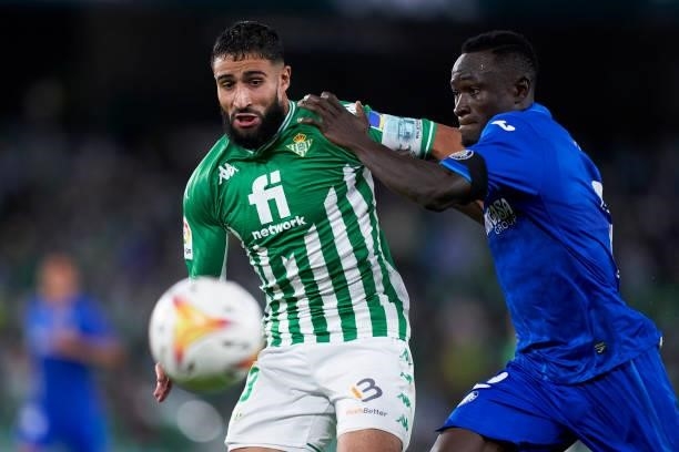 Nabil Fekir of Real Betis competes for the ball with Dakonam Djene of Getafe CF during the LaLiga Santander match between Real Betis and Getafe CF at...