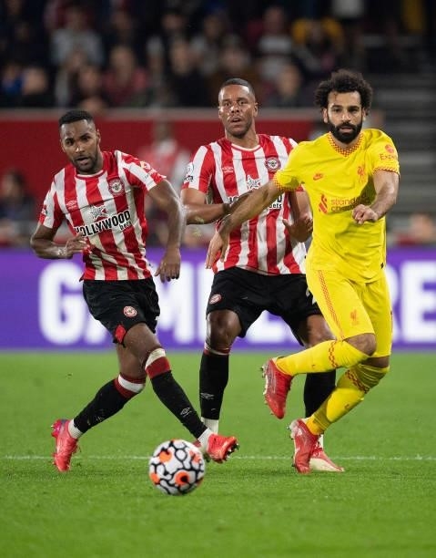Rico Henry and Mathias Jørgensen of Brentford and Mohamed Salah of Liverpool during the Premier League match between Brentford and Liverpool at...