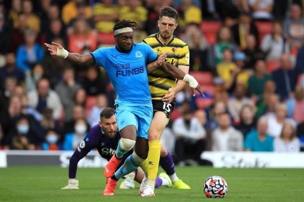 Allan Saint-Maximin of Newcastle United and Craig Cathcart of Watford during the Premier League match between Watford and Newcastle United at...