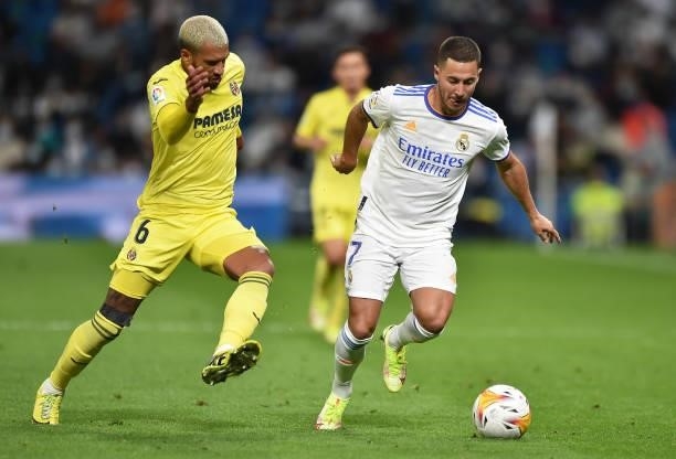 Eden Hazard of Real Madrid is challenged by Etienne Capoue of Villareal FC during the La Liga Santander match between Real Madrid CF and Villarreal...