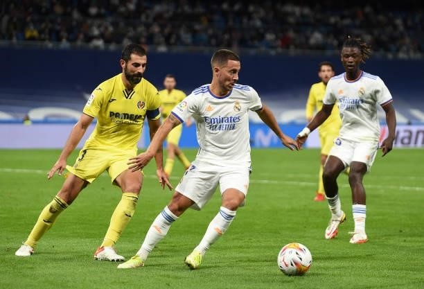 Eden Hazard of Real Madrid is challenged by Raul Albiol of Villareal FC reacts during the La Liga Santander match between Real Madrid CF and...