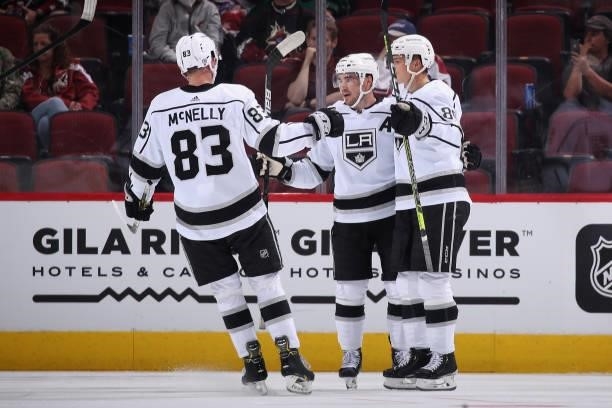 Sean Walker of the Los Angeles Kings celebrates with Cade McNelly and Rasmus Kupari after scoring a goal against the Arizona Coyotes during the...