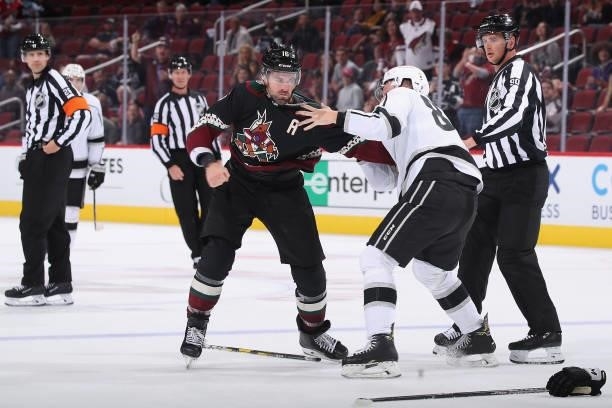 Cade McNelly of the Los Angeles Kings and Andrew Ladd of the Arizona Coyotes fight during the second period of the preseason NHL game at Gila River...