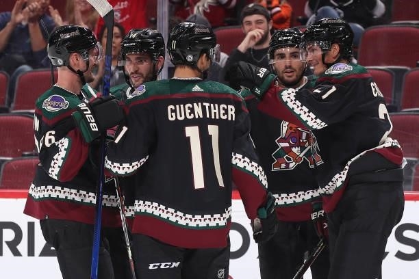 Loui Eriksson of the Arizona Coyotes celebrates with Dylan Guenther, Anton Stralman, Shayne Gostisbehere and Nick Schmaltz after Eriksson scored a...