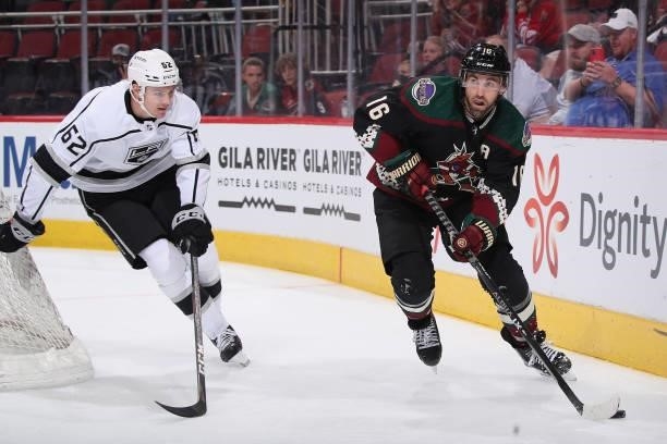 Andrew Ladd of the Arizona Coyotes skates with the puck ahead of Helge Grans of the Los Angeles Kings during the second period of the preseason NHL...