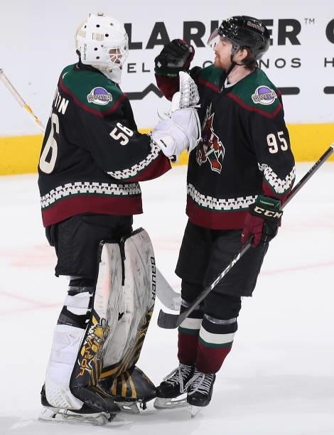 Goaltender Anson Thornton of the Arizona Coyotes celebrates with Cameron Crotty after defeating the Los Angeles Kings in the preseason NHL game at...