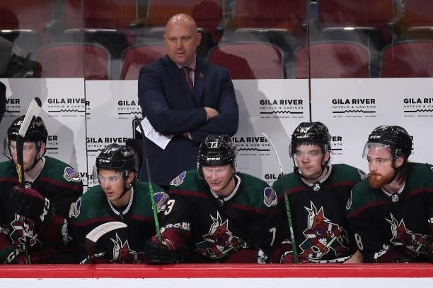 Head coach Andre Tourigny of the Arizona Coyotes watches from the bench during the third period of the preseason NHL game against the Los Angeles...