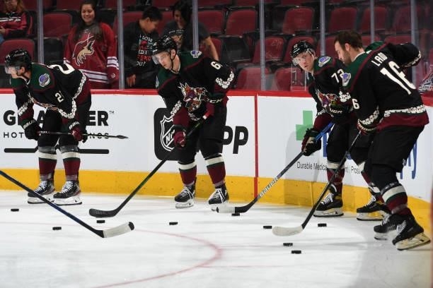 Andrew Ladd, Travis Boyd, Dysin Mayo and Loui Eriksson of the Arizona Coyotes prepare for a game against the Los Angeles Kings at Gila River Arena on...