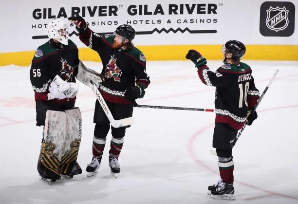 Goaltender Anson Thornton of the Arizona Coyotes celebrates with Liam O'Brien and Ryan Dzingel after defeating the Los Angeles Kings in the preseason...