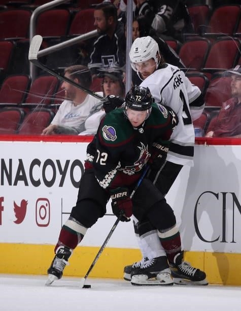 Travis Boyd of the Arizona Coyotes battles for the puck with Adrian Kempe of the Los Angeles Kings during the third period of the preseason NHL game...